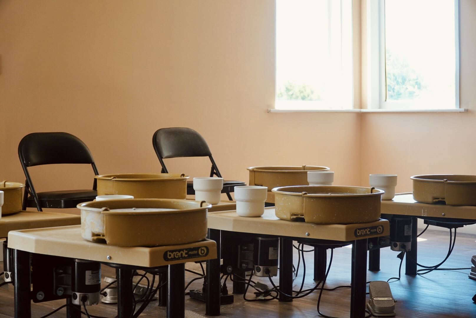 Group doing pottery together at a private event at Olomana Studios